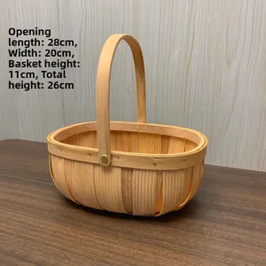 Handwoven oval wicker basket with sturdy wooden handle and dimensions 28x20x11cm