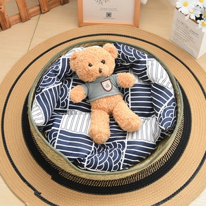 Detail of round straw pet bed with wave pattern cushion and cozy rustic home decor