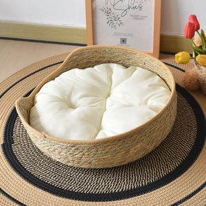 Detail of hand-woven cattail cat bed with cute cat ear design and soft white cushion