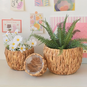 Detail of hand-woven seagrass planters with waterproof plastic liner for indoor plants