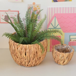 Detailed macro view of woven water hyacinth plant basket with waterproof plastic lining