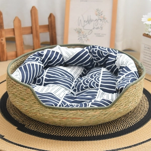 Detail of hand-woven cattail pet bed with circular design and blue patterned cushion