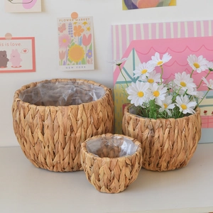 Three-piece woven seagrass plant baskets with waterproof liners in natural brown finish