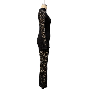 Detail of floral lace texture on slim fit jumpsuit with flared long sleeves in black