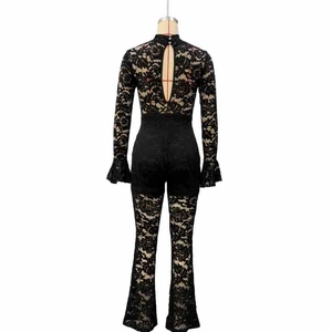 Detailed back view of black lace jumpsuit featuring keyhole cutout and flared bell sleeves