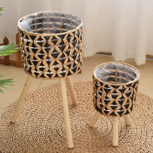 Detailed view of hand-woven plant baskets with wooden legs and waterproof inner lining