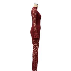 Detail of burgundy lace bodysuit with elegant flare sleeves and high neckline texture