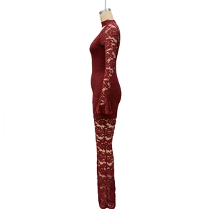 Close-up of burgundy lace jumpsuit featuring intricate floral patterns and ruffled bell sleeves