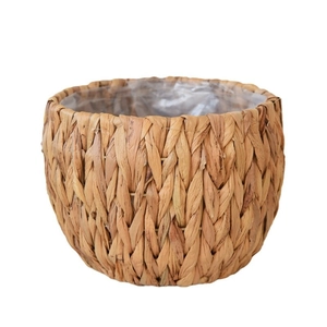 Handwoven seagrass plant basket with waterproof plastic liner on white background