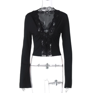 Close-up of black V-neck cropped top with delicate lace trim and button detail