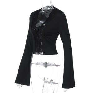 Detailed view of black deep V-neck crop top with lace trim and flared bell sleeves