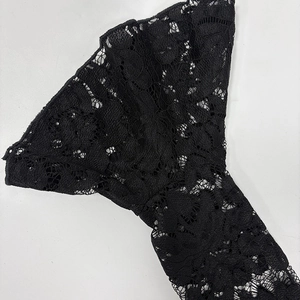 Close-up of intricate black lace flare sleeves featuring floral hollow-out embroidery