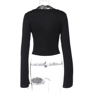Close-up of black long sleeve top featuring delicate lace trim on the back neckline