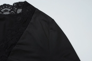 Detail of delicate black floral lace trim on V-neck button cardigan top for women