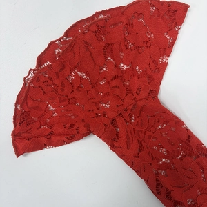 Detail of elegant red floral lace bell sleeves with high saturation and hollow texture
