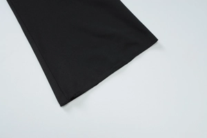 Detailed close-up of the black lace cardigan flared sleeve with premium stitching detail