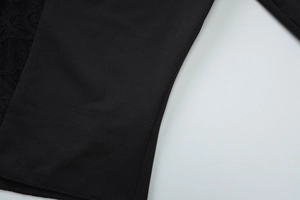 Close-up of elegant black lace stitching and high-quality knit fabric on the top