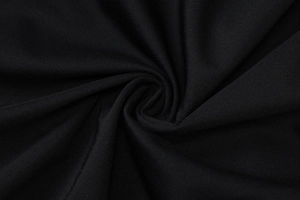 Close-up of black knit fabric texture showing fine twill weave and soft draped folds