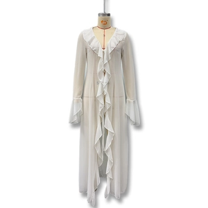 Detail of the white lace trim and flowing bell sleeves on a sheer beach cardigan