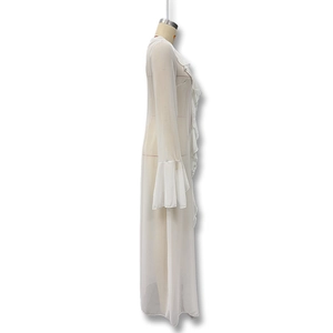 Detail view of the layered ruffles and sheer fabric texture on the long white cover-up