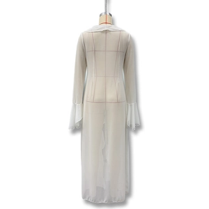 Detail of white semi-transparent long lace cardigan with bell sleeves for beach style