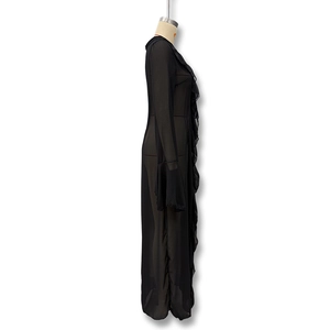 Detail of sheer black mesh dress with ruffled lace edges and long bell sleeves