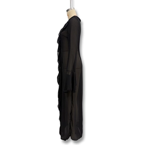 Detail of black sheer mesh cover-up featuring ruffled edges and elegant flare sleeves