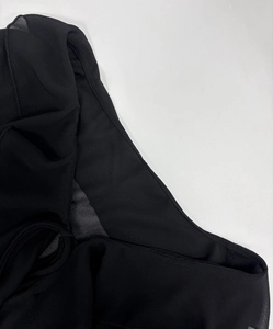 Close-up of black sheer chiffon fabric with delicate ruffles and layered pleats detail