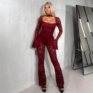 Macro detail of wine red lace jumpsuit showing flared sleeves and cutout design