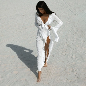 White long-sleeved boho dress with V-neck, lace details and wrap-around beach style