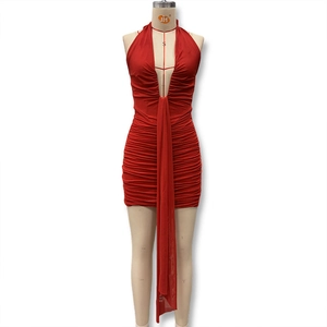 Detail of red ruched bodycon dress with deep V-neckline and decorative hanging ribbon