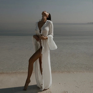 Close-up of elegant ruffled cuffs and sheer white chiffon fabric on beach cover-up