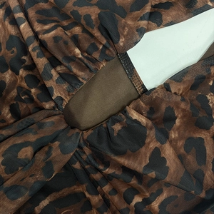 Close-up of leopard print mesh fabric with intricate pleating and ruching details