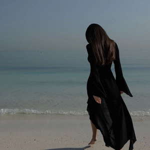 Elegant black long sleeve beach dress featuring vintage bell sleeves and a backless view