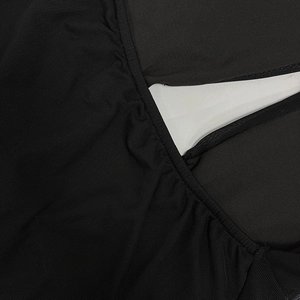 Detail shot of sheer black mesh fabric with fine hole texture for a sexy slim-fit dress