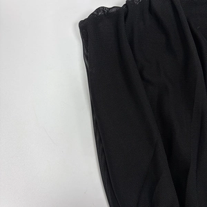 Close-up of black mesh fabric with fine hexagonal net structure and sheer texture