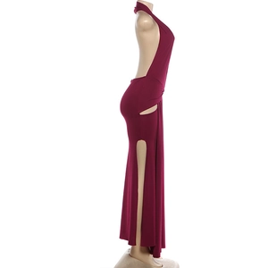 Detail view of the deep red backless halter maxi dress with a sexy high side slit