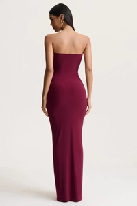 Rear view of sleek burgundy strapless maxi dress in form-fitting knit fabric