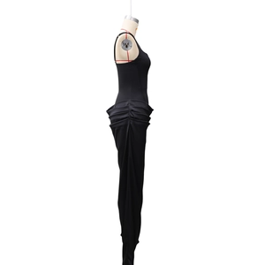 Close-up of the elegant side ruching and floor-length fishtail hem on the black dress
