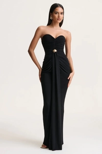 Detailed view of black strapless evening gown with pleated waist and golden metal buckle