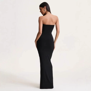 Elegant back view of a slim-fit sleeveless black tube evening gown with floor-length hem
