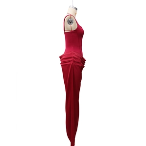 Detail of red bodycon dress featuring elegant side ruching and slim fit texture