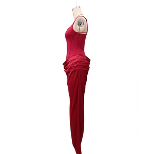 Detail of red satin bodycon evening dress featuring elegant side ruching and glossy finish