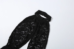 Close-up of intricate black lace patterns and halter neck detail on a slim fit bodysuit