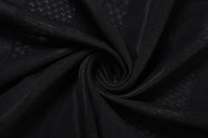 Détail macro du tissu en maille noire respirante montrant une texture fine et douce