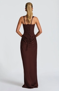 Detail of elegant back view showing the corset-style lace-up closure on the brown dress