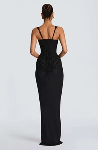 Detail of the cross-back lace-up corset design on a slim black evening dress