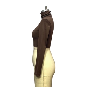 Detailed side view of a brown long-sleeve crop top with a high turtleneck and slim-fit cut