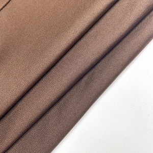Close-up of dark brown ribbed knit fabric showing the detailed vertical texture and weave