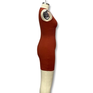 Close-up of rust orange sleeveless knit rib dress with textured vertical fabric detail